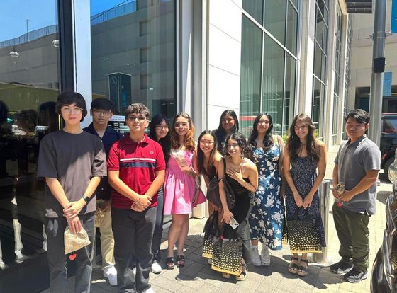 big group photo with friends outside a building