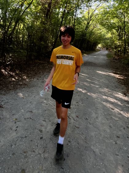 Ethan walking down a tree-covered trail